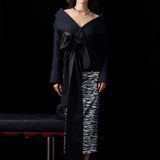 A woman wearing a glamorous high-waisted pencil skirt featuring shimmering silver and black sequins in a stylish zebra print, ideal for an elegant evening party or a night out.