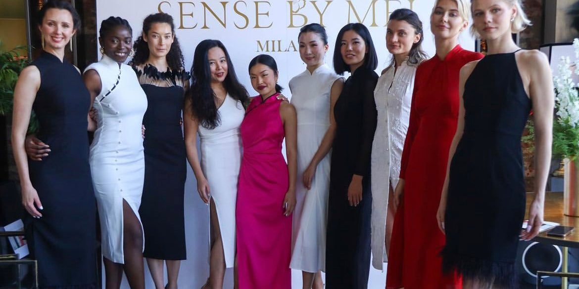 Founder of Sense By Mei posing with women of diverse ethnicities, all elegantly dressed in the brand's signature dresses, celebrating global beauty and unity.