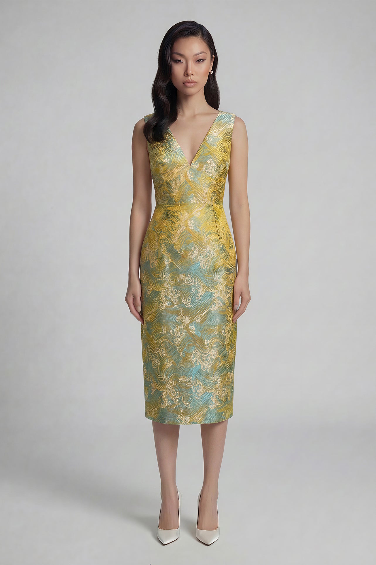 A professional woman wearing a stunning gold and teal jacquard sheath dress, featuring a sophisticated V-neckline and elegant artistic wave patterns for a high-end formal look.