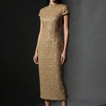 A professional woman wearing a stunning luxurious gold sequined modern qipao dress, featuring a traditional mandarin collar, short cap sleeves, and a slim-fit floor-length silhouette for a formal evening gala.