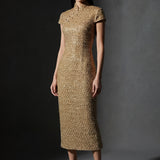 A professional woman wearing a stunning luxurious gold sequined modern qipao dress, featuring a traditional mandarin collar, short cap sleeves, and a slim-fit floor-length silhouette for a formal evening gala.