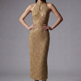 A stunning professional model wearing a luxurious gold sequined halter neck evening gown, featuring a sophisticated keyhole neckline and a slim-fit silhouette for a formal gala look.