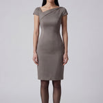 A professional woman wearing a sophisticated taupe grey sheath dress, featuring a chic asymmetric neckline, cap sleeves, and a tailored slim-fit silhouette for an elegant office look.