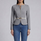 A professional woman wearing a sophisticated grey pinstripe zip-up blazer, featuring a thin white belt with a gold buckle and a tailored slim fit for a modern office look.