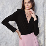 A professional woman wearing sophisticated high-waisted wide-leg pinstripe trousers in charcoal black, featuring a tailored slimming fit for a powerful executive office look.