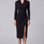 A professional woman wearing a sophisticated dark plum long-sleeve wrap dress, featuring a deep V-neckline, flattering ruched side detailing, and an elegant side slit for a formal evening or executive look.