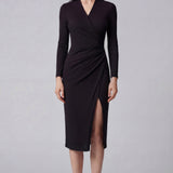 A professional woman wearing a sophisticated dark plum long-sleeve wrap dress, featuring a deep V-neckline, flattering ruched side detailing, and an elegant side slit for a formal evening or executive look.