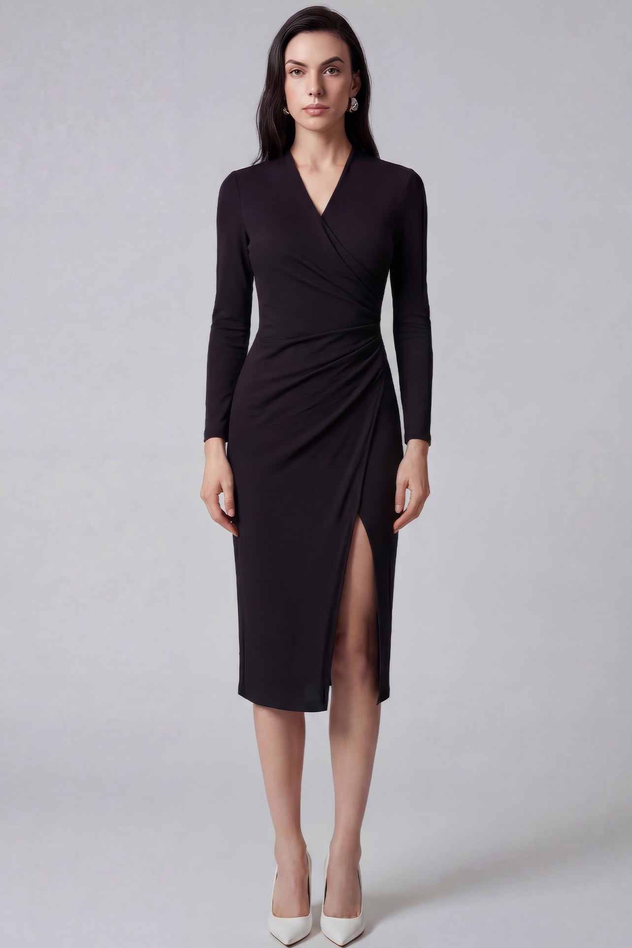 A professional woman wearing a sophisticated dark plum long-sleeve wrap dress, featuring a deep V-neckline, flattering ruched side detailing, and an elegant side slit for a formal evening or executive look.