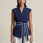 A group of elegant women wearing sophisticated modern qipao dresses in various colors like white, purple, yellow, and black, styled with luxurious fur shawls and embroidery for a high-end social gathering.