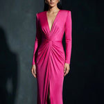 A sophisticated woman wearing a vibrant magenta long-sleeve dress, featuring a plunging V-neckline and an elegant knot-front twist at the waist for a stunning evening gala look.
