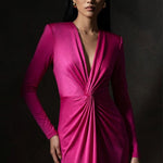 A sophisticated woman wearing a vibrant magenta long-sleeve dress, featuring a plunging V-neckline and an elegant knot-front twist at the waist for a stunning evening gala look.