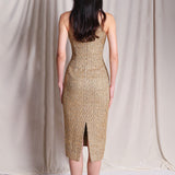 A stunning professional model wearing a luxurious gold sequined halter neck evening gown, featuring a sophisticated keyhole neckline and a slim-fit silhouette for a formal gala look.