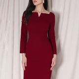 A professional woman wearing a sophisticated black long-sleeve midi dress, featuring a unique notched square neckline and a tailored slim-fit pencil silhouette for a polished executive office look.