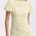 A professional woman wearing a sophisticated pale yellow short-sleeve midi dress, featuring elegant puff sleeves and a slimming ruched waistline for a polished and fresh summer office look.
