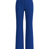 A professional woman wearing sophisticated royal blue high-waisted wide-leg trousers, featuring a tailored loose-fit silhouette for a modern and vibrant executive office look.
