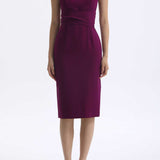 A professional woman wearing a sophisticated magenta v-neck sleeveless midi dress, featuring a tailored slim-fit pencil silhouette for a polished executive office or cocktail look.