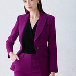 A professional woman wearing a sophisticated black belted blazer dress, featuring a tailored slim-fit silhouette with a waist-defining belt for a powerful executive business look.
