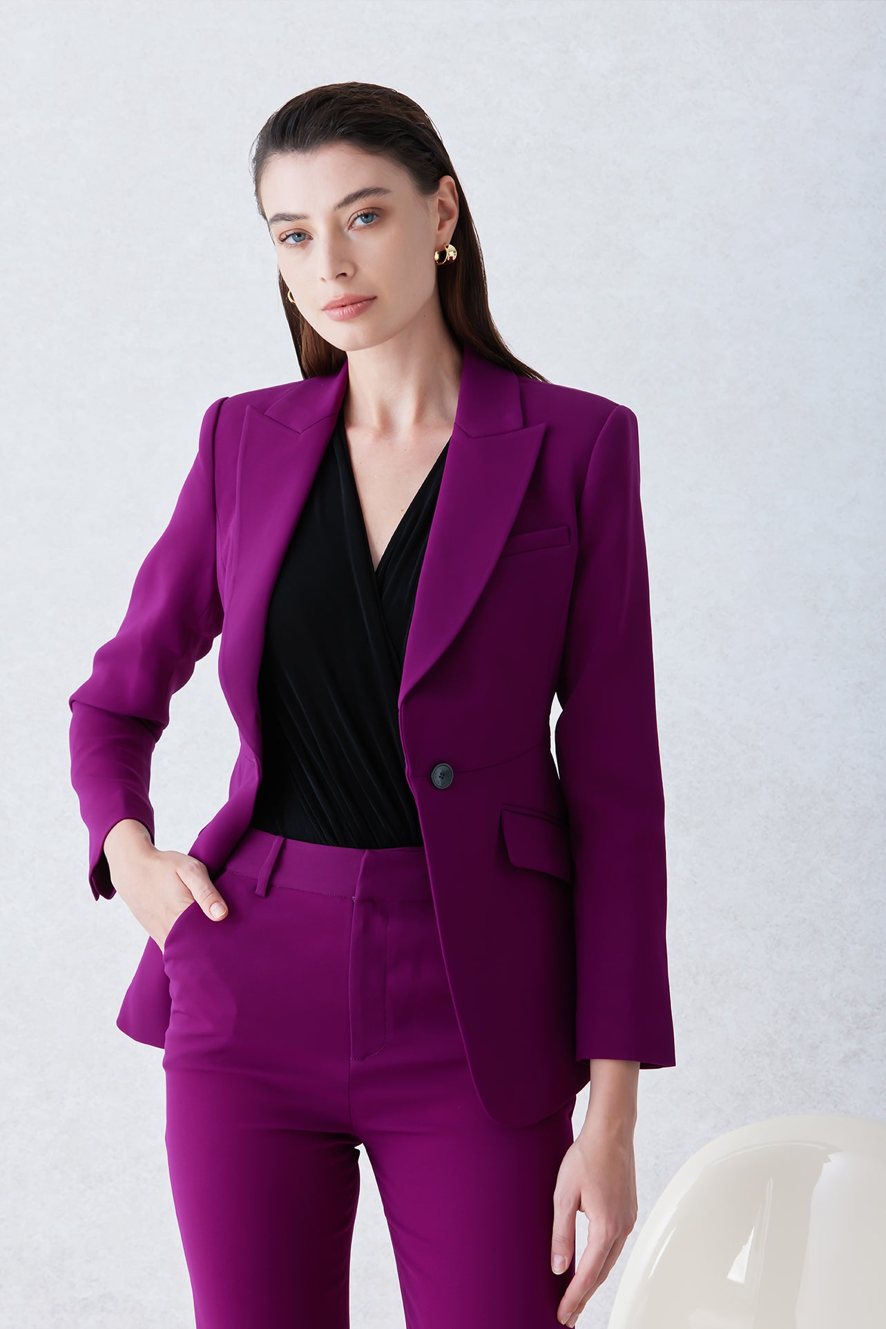 A professional woman wearing a sophisticated black belted blazer dress, featuring a tailored slim-fit silhouette with a waist-defining belt for a powerful executive business look.