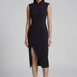 A professional woman wearing a sophisticated black modern qipao, featuring a classic mandarin collar, sleeveless slim-fit silhouette, and elegant side buttons with a high-low slit for a timeless oriental chic look.