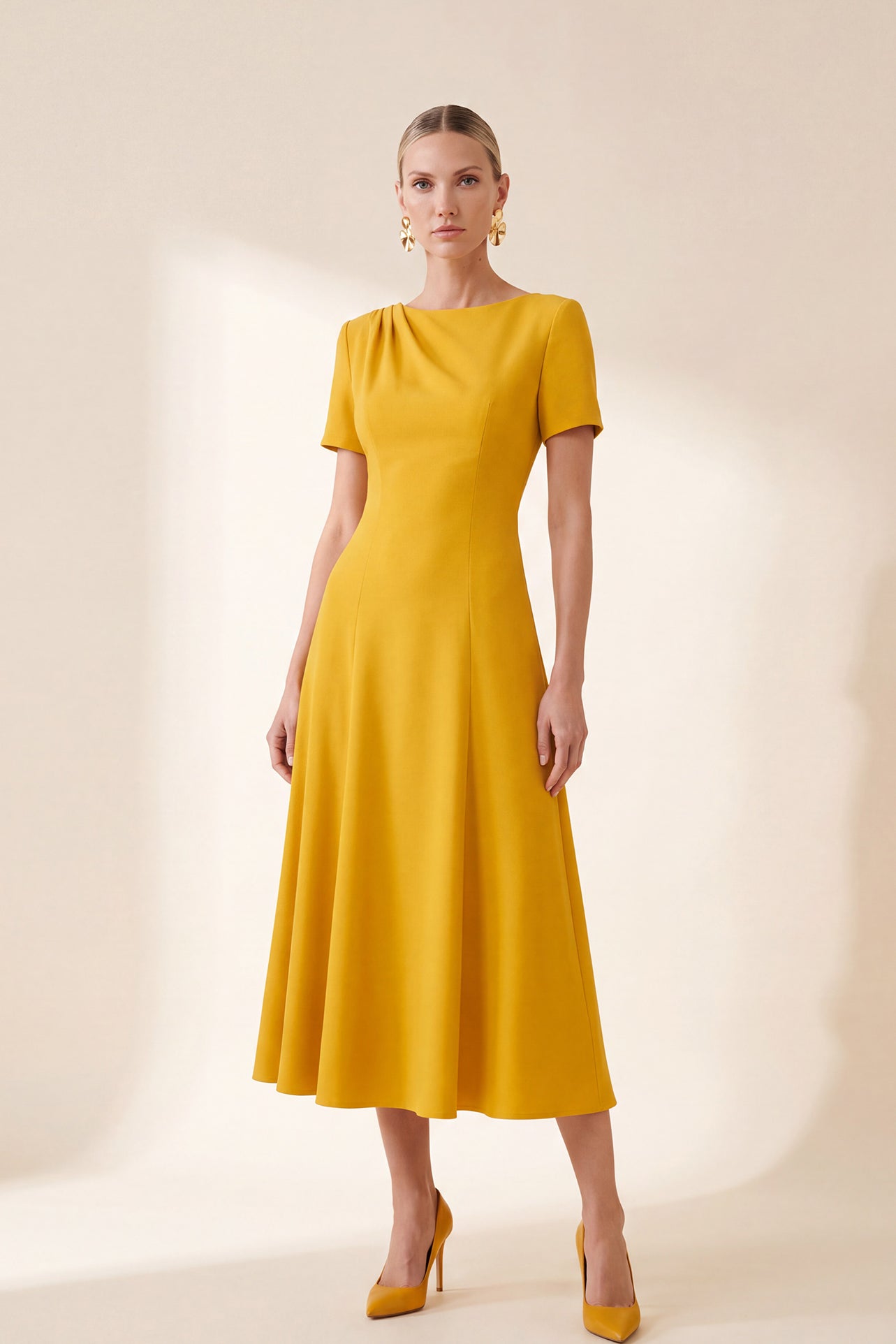A professional Asian woman wearing glasses and an elegant black tailored blazer featuring a striking mustard yellow contrast shawl lapel, statement front button, and buttoned cuffs for a sophisticated intellectual corporate look.