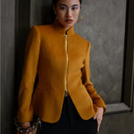A chic professional Asian woman wearing a luxurious camel wool tailored jacket featuring a sleek stand collar, exposed two-way front zipper, structured shoulders, and an hourglass silhouette paired with a matching skirt.