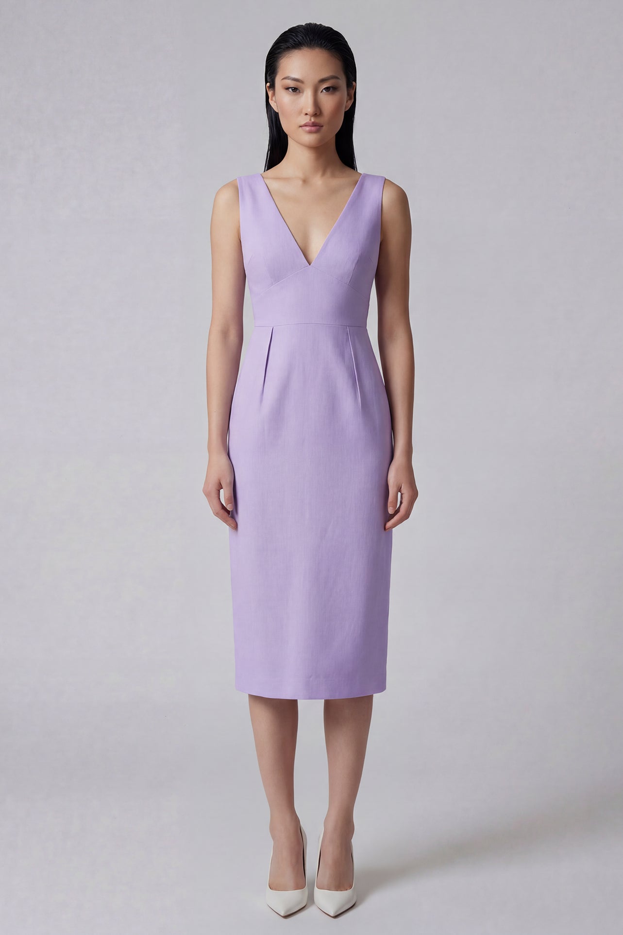 A professional woman showcasing two elegant sleeveless V-neck sheath dresses in classic black and soft lilac purple, featuring functional side pockets and a tailored fit for a polished office look.
