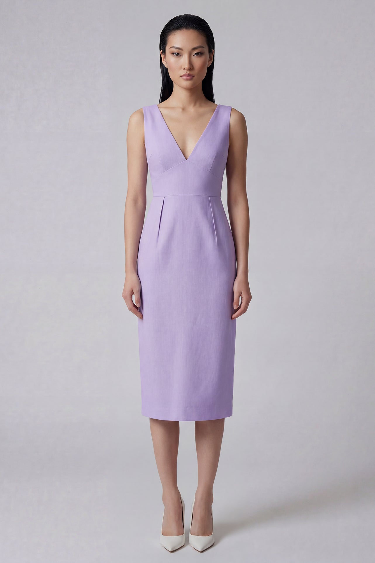 A professional woman showcasing two elegant sleeveless V-neck sheath dresses in classic black and soft lilac purple, featuring functional side pockets and a tailored fit for a polished office look.