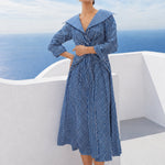 A style comparison of two elegant long-sleeve shirt maxi dresses featuring a unique twist knot waist design; the left showcasing a minimalist solid white dress with a popped collar, and the right featuring a classic blue and white vertical striped dress with a flattering A-line flare skirt.
