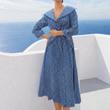 A style comparison of two elegant long-sleeve shirt maxi dresses featuring a unique twist knot waist design; the left showcasing a minimalist solid white dress with a popped collar, and the right featuring a classic blue and white vertical striped dress with a flattering A-line flare skirt.