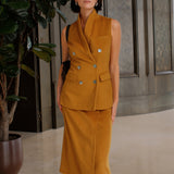 An elegant Asian woman posing in a luxurious camel wool two-piece suit featuring a sleeveless double-breasted longline vest cinched with a wide black belt, paired with a matching midi column skirt and black opera gloves.