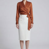 A professional woman wearing a sophisticated high-waisted white pencil skirt featuring elegant double-breasted button decorations and a slimming tailored fit, ideal for corporate business wear.