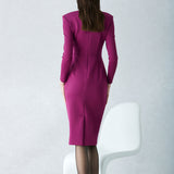 A professional woman wearing a sophisticated deep magenta long-sleeve pencil dress, featuring a unique square neckline and elegant ruched detailing at the waist for a flattering, slim-fit executive look.