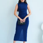 A professional woman wearing a sophisticated navy blue sleeveless midi dress, featuring an elegant high neckline and flattering ruched detailing along the side for a slim-fit executive look.
