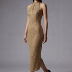 A stunning professional model wearing a luxurious gold sequined halter neck evening gown, featuring a sophisticated keyhole neckline and a slim-fit silhouette for a formal gala look.