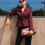 A professional Asian woman wearing glasses and an elegant deep burgundy tailored blazer featuring a sophisticated stand collar with a split V-neckline, structured shoulders, and a clean minimalist front.
