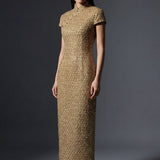 A professional woman wearing a stunning luxurious gold sequined modern qipao dress, featuring a traditional mandarin collar, short cap sleeves, and a slim-fit floor-length silhouette for a formal evening gala.