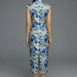 A professional woman wearing a sophisticated modern qipao dress, featuring a blue and white porcelain floral print, a mandarin collar with keyhole detail, and a slimming tailored fit for an elegant executive look.