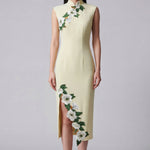 A professional woman wearing a stunning pale yellow sleeveless dress, featuring a traditional mandarin collar, exquisite white floral embroidery appliques along the neckline and hem, and an elegant side slit for a sophisticated modern oriental look.