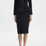 A professional woman wearing a sophisticated cream tweed skirt suit, featuring a tailored jacket with a modern front zipper and an elegant stand collar for a polished executive office look.