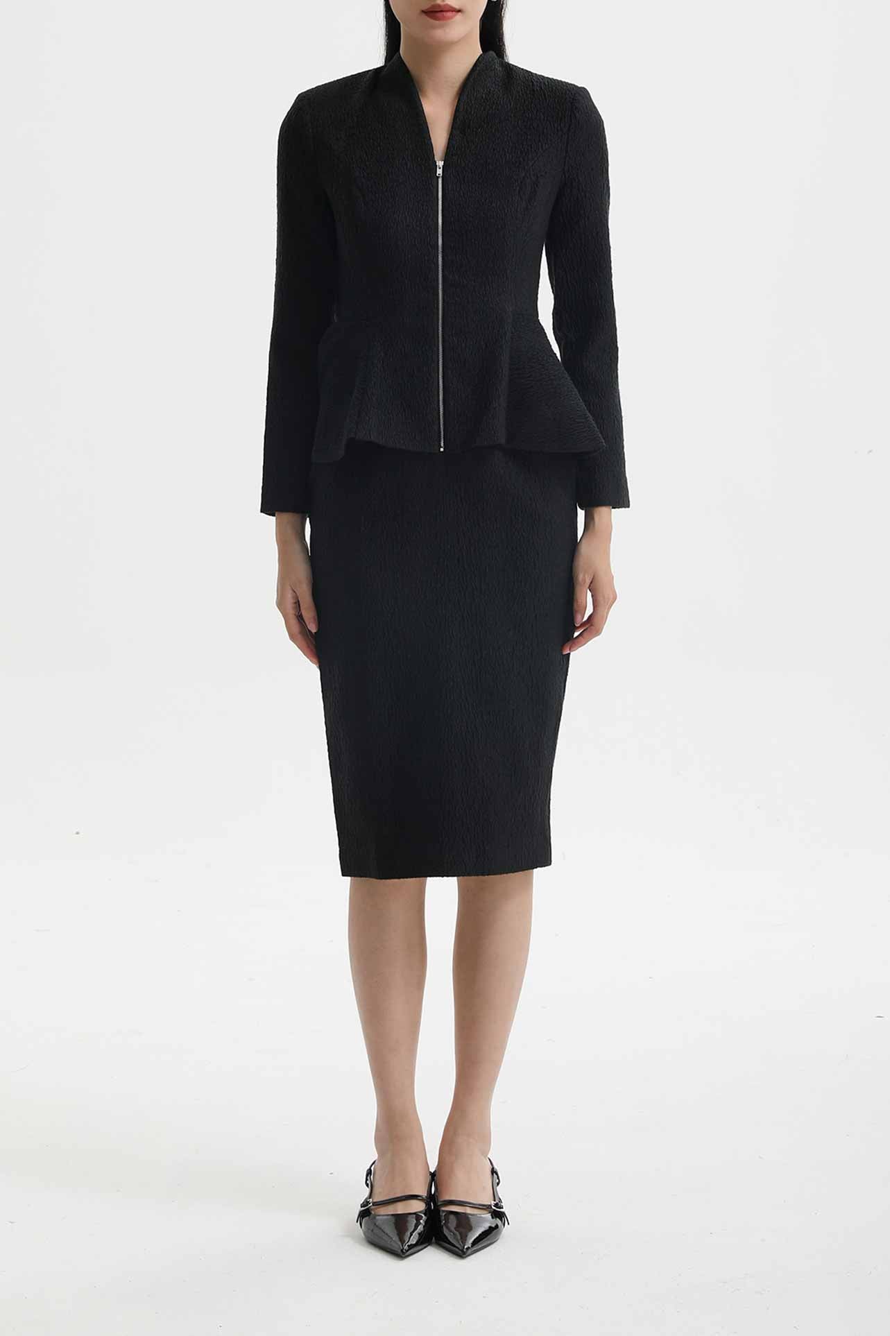 A professional woman wearing a sophisticated cream tweed skirt suit, featuring a tailored jacket with a modern front zipper and an elegant stand collar for a polished executive office look.