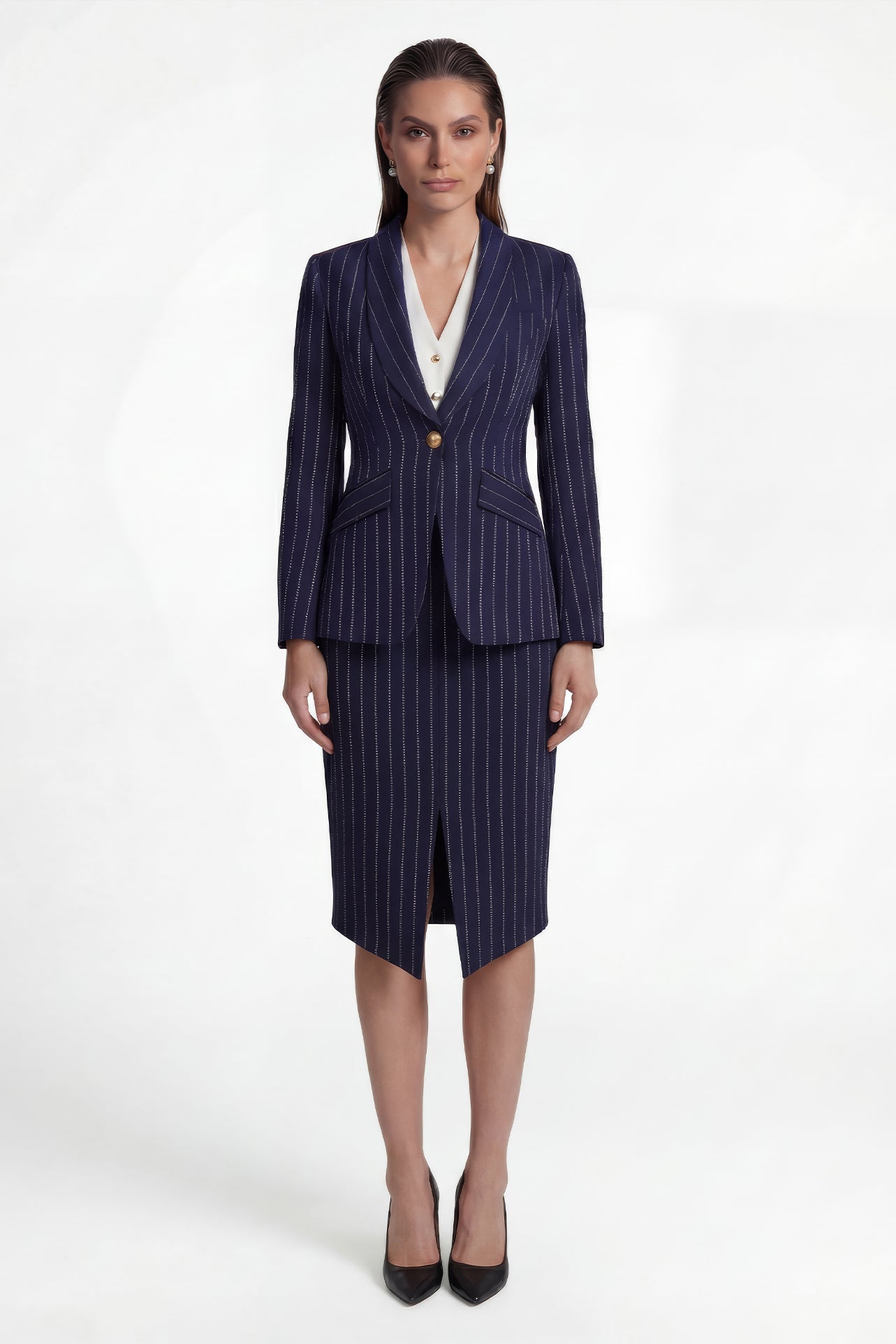 A professional woman wearing a sophisticated navy blue pinstripe suit, featuring a tailored single-button blazer and a matching midi pencil skirt with a front slit for an elegant executive office look.