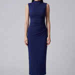 A professional woman wearing a sophisticated navy blue sleeveless midi dress, featuring an elegant high neckline and flattering ruched detailing along the side for a slim-fit executive look.