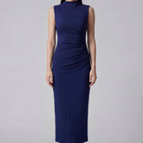 A professional woman wearing a sophisticated navy blue sleeveless midi dress, featuring an elegant high neckline and flattering ruched detailing along the side for a slim-fit executive look.