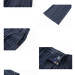 A professional woman wearing sophisticated navy blue pinstripe wide-leg trousers, featuring a high-waisted tailored fit and elegant vertical stripes for a polished executive office look.