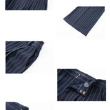 A professional woman wearing sophisticated navy blue pinstripe wide-leg trousers, featuring a high-waisted tailored fit and elegant vertical stripes for a polished executive office look.