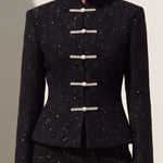 A chic woman wearing a luxurious black sparkle tweed tailored jacket featuring an authentic stand cheongsam collar, elegant horizontal pearl bar closures, and a flattering hourglass waistline.