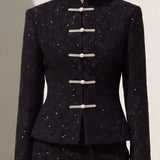 A chic woman wearing a luxurious black sparkle tweed tailored jacket featuring an authentic stand cheongsam collar, elegant horizontal pearl bar closures, and a flattering hourglass waistline.