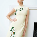 A professional woman wearing a stunning lemon yellow sleeveless mini dress, featuring a traditional mandarin collar, exquisite white floral 3D embroidery, and an elegant side slit for a sophisticated modern oriental look.