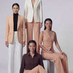 A professional woman wearing sophisticated apricot-colored high-waisted straight-leg trousers, featuring a unique pointed waistband design for a tailored executive office look.