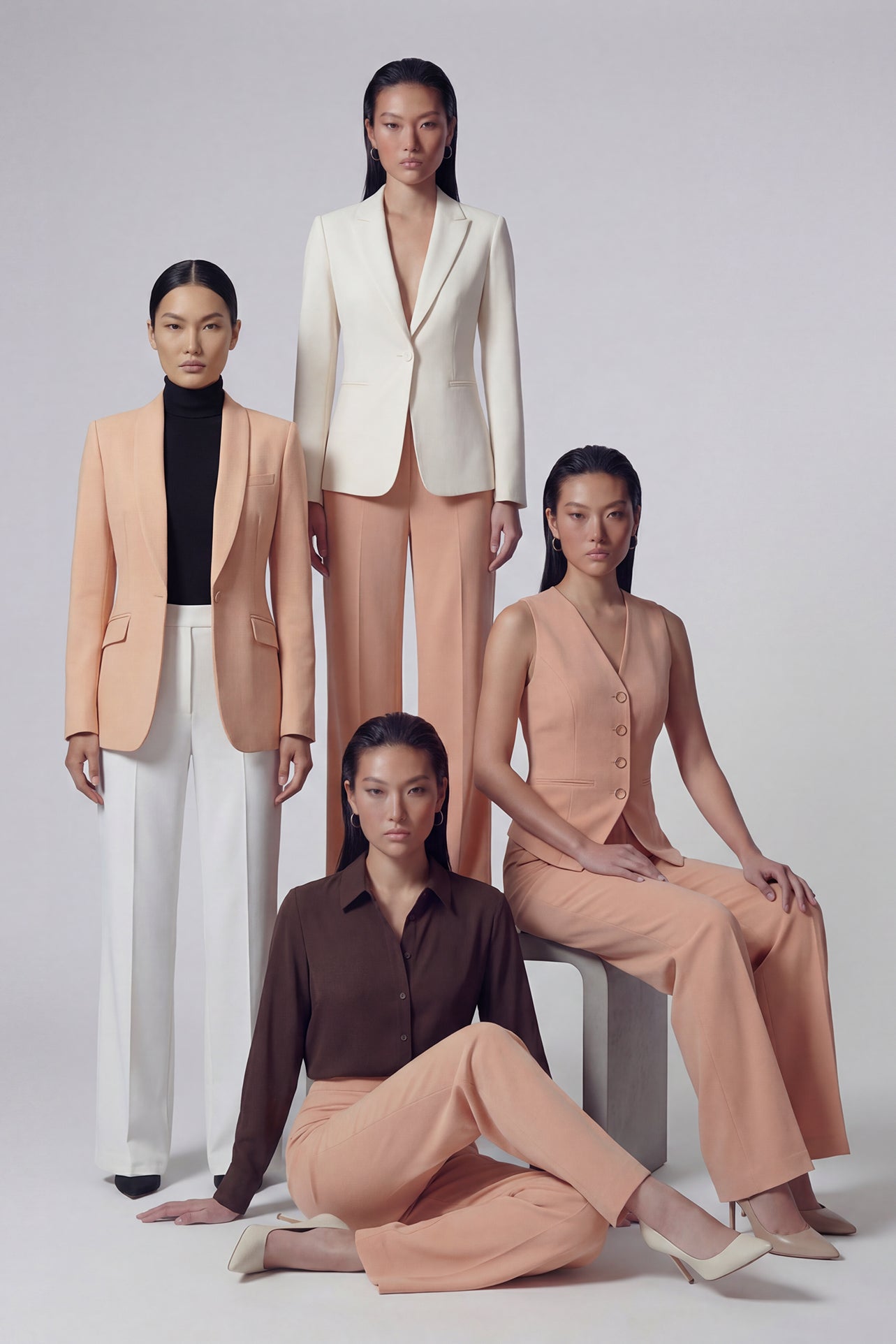 A professional woman wearing sophisticated apricot-colored high-waisted straight-leg trousers, featuring a unique pointed waistband design for a tailored executive office look.